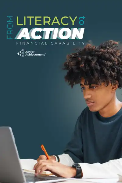 A young man typing on a laptop.